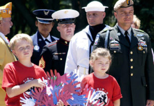 A Memorial Day event at Arlington National Cemetery, with children remembering their father’s sacrifice.