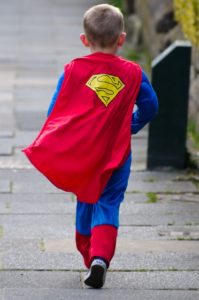 A child dressed up as Superman.