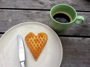A waffle served in the shape of a heart.
