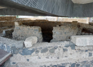 The photo shows the ruins of the octagonal church in Capernaum. A modern church has been built over the ancient site.