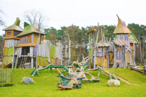 A wooden playground made to look like a castle.