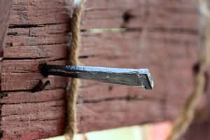 A nail on a wooden cross.