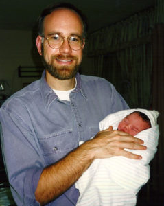 Mark Roberts holding his daughter.