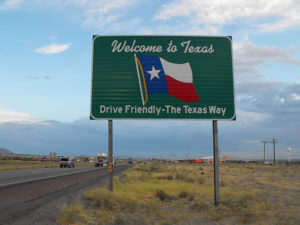 Photo of a road sign that reads "Drive Friendly – The Texas Way". 