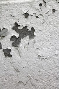 Cracked and peeling paint on a wall.