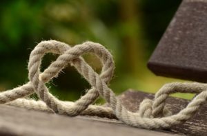 A knotted rope with a heart shaped knot in the middle.