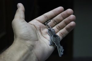 An open hand, holding a set of keys.