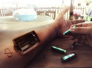A person seemingly replacing the batteries in their arm as a sign of needing to recharge.