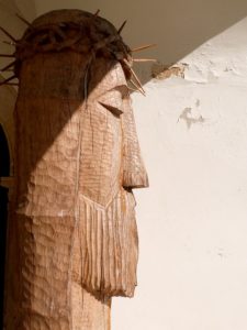A wooden sculpture of Jesus's head with a crown of thorns.