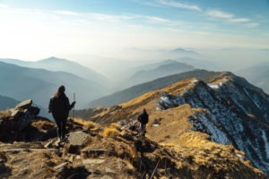 People walking along a peaceful and majestic mountain ridge.
