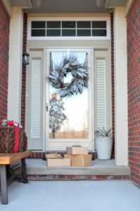 The front door of a home decorated for the holidays.
