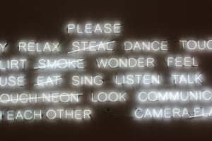 A collection of neon sign words, with some attributes crossed out.
