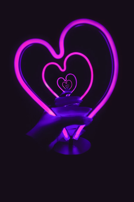 Neon lit heart reflecting to infinity.