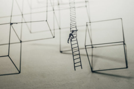 A figurine person climbing a long ladder with no foreseeable end.