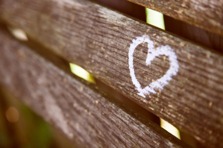 A heart etched on a wooden fence.