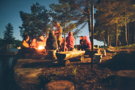 People sitting around a campfire.