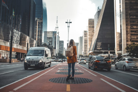 A woman walking on a busy city street.