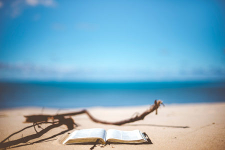 A Bible on a lakeshore.