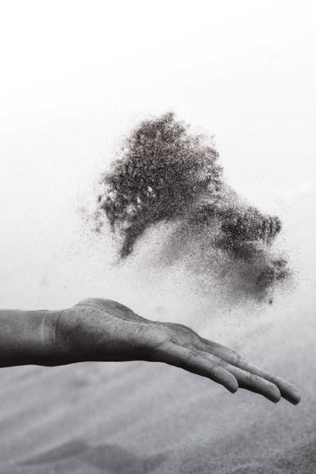 Sand being released from an open hand.