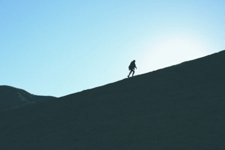 A person walking up a steep incline.