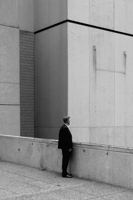 A man standing by a building.